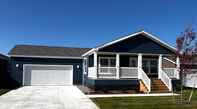 view of front of house featuring covered porch, stairs, concrete driveway, a front lawn, and a garage