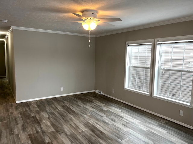 unfurnished room featuring baseboards, visible vents, dark wood-style flooring, and ornamental molding