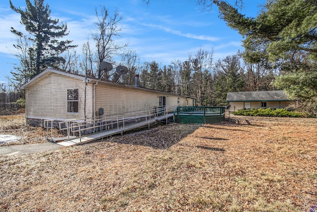 view of property exterior with a deck