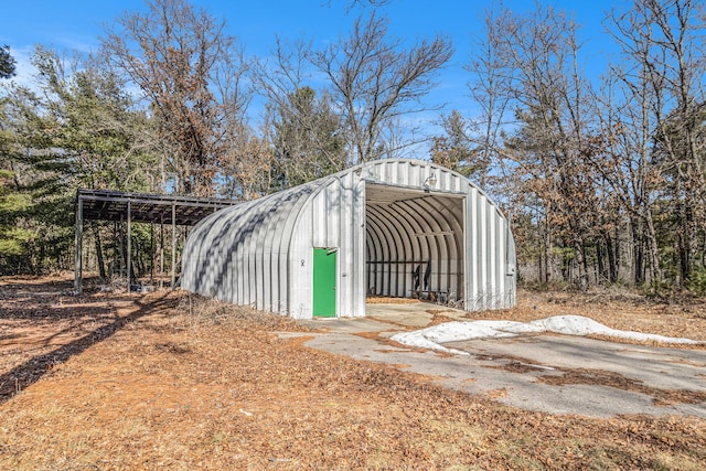 view of pole building with dirt driveway