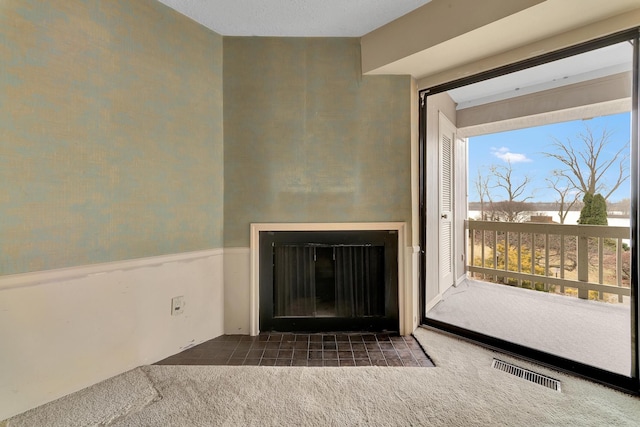 room details featuring visible vents, carpet flooring, and a wainscoted wall