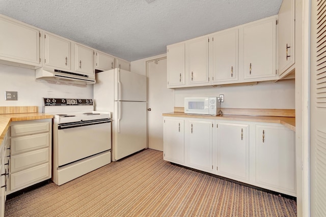 kitchen featuring under cabinet range hood, white appliances, a textured ceiling, and light countertops