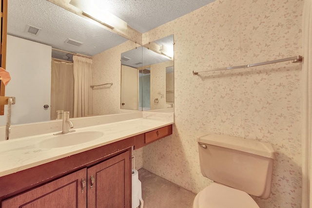 bathroom featuring wallpapered walls, a textured ceiling, and toilet