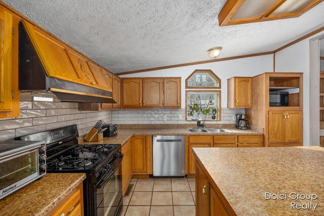 kitchen with ornamental molding, black appliances, custom range hood, and a sink