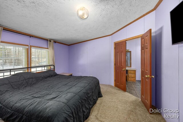 bedroom featuring ornamental molding, a textured ceiling, and carpet floors