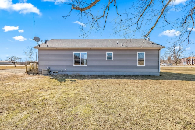 back of house with a lawn