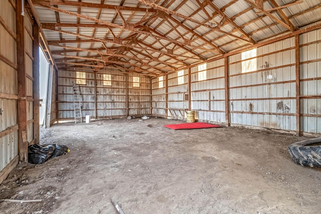 misc room featuring metal wall and vaulted ceiling