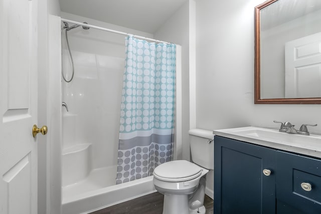 bathroom featuring toilet, vanity, and a shower with shower curtain