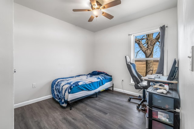 bedroom with a ceiling fan, wood finished floors, and baseboards