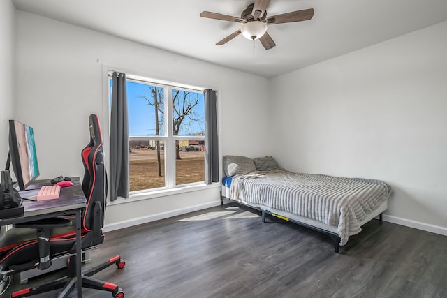 bedroom with ceiling fan, baseboards, and wood finished floors