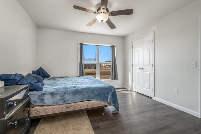 bedroom featuring dark wood finished floors, ceiling fan, and baseboards