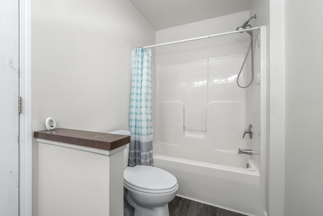 bathroom featuring shower / bathtub combination with curtain, toilet, and wood finished floors