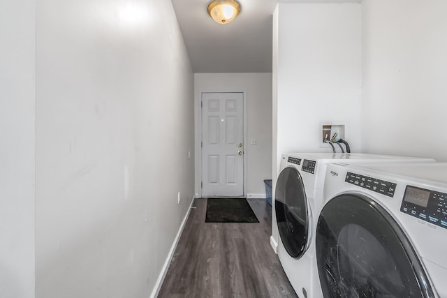 laundry room featuring washer and dryer, baseboards, dark wood-style floors, and laundry area