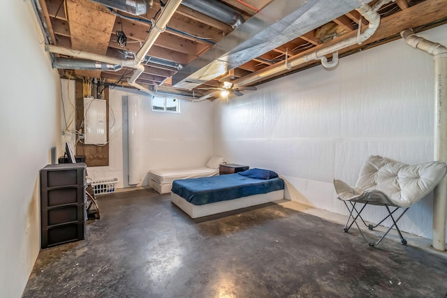 bedroom with electric panel and concrete flooring