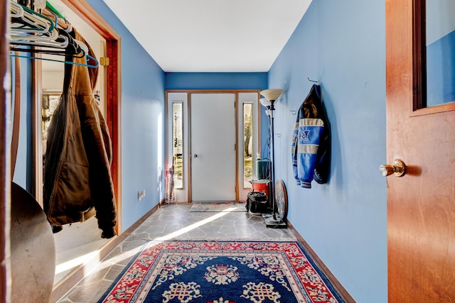 foyer featuring baseboards