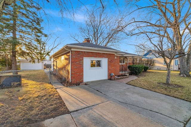 view of front facade featuring a front lawn, fence, concrete driveway, brick siding, and a chimney