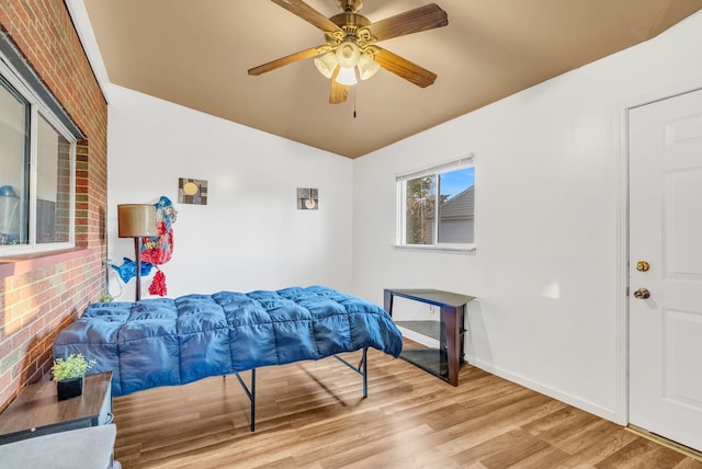 bedroom featuring ceiling fan, baseboards, and wood finished floors