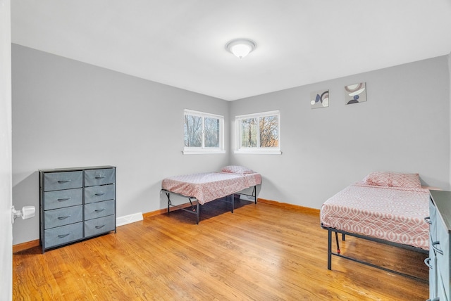 bedroom featuring baseboards and wood finished floors