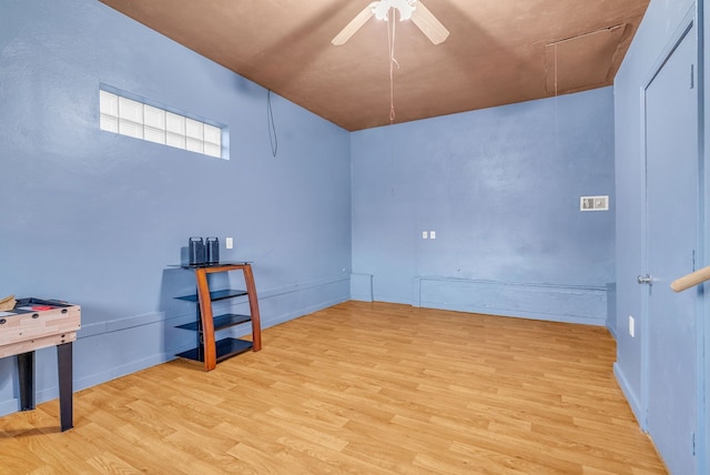 unfurnished room featuring light wood-style flooring, attic access, and ceiling fan