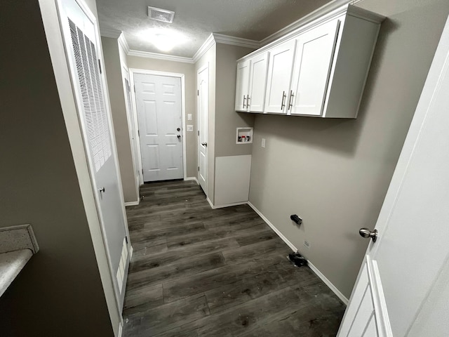 washroom featuring visible vents, dark wood-style floors, crown molding, baseboards, and laundry area