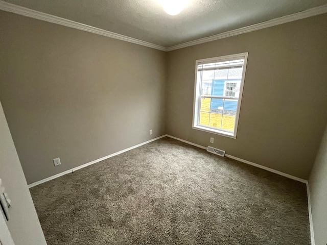 unfurnished room with visible vents, baseboards, carpet, and crown molding