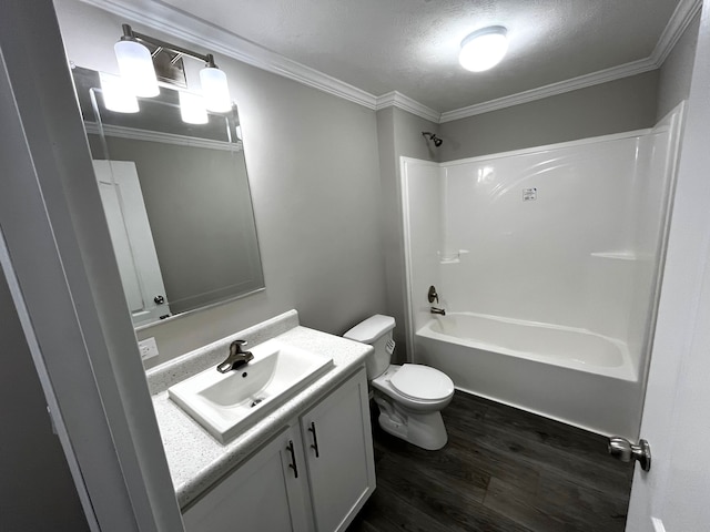 bathroom featuring tub / shower combination, crown molding, toilet, wood finished floors, and vanity