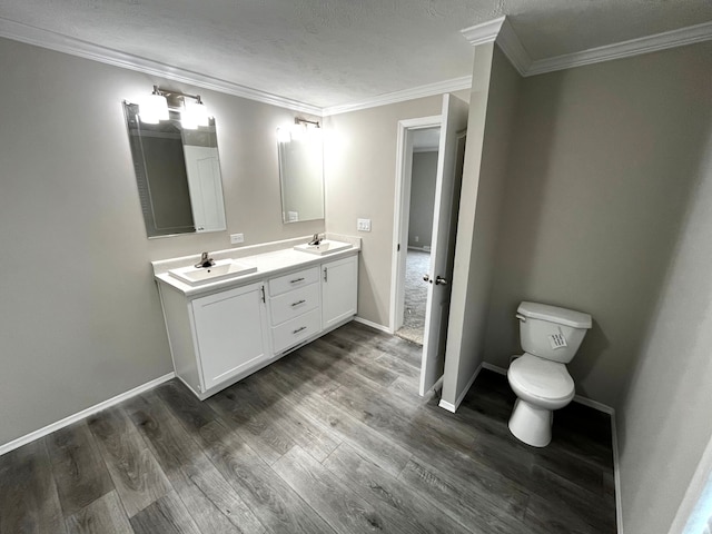 full bath with double vanity, wood finished floors, baseboards, and a sink