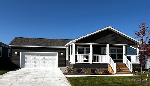 view of front of property with driveway, covered porch, a front yard, an attached garage, and stairs