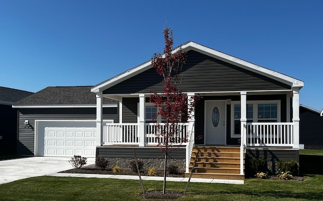 view of front of house with a front yard, roof with shingles, a porch, concrete driveway, and a garage