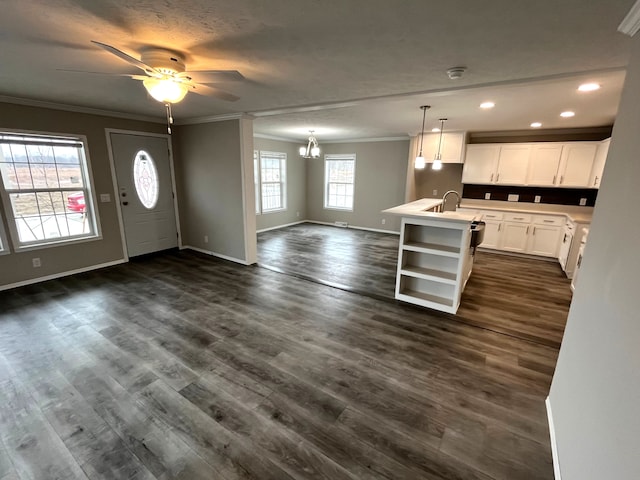 kitchen with open shelves, open floor plan, dark wood finished floors, and ornamental molding