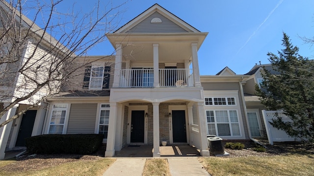 view of front of property featuring a balcony and a porch