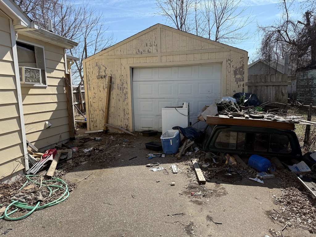 detached garage featuring fence