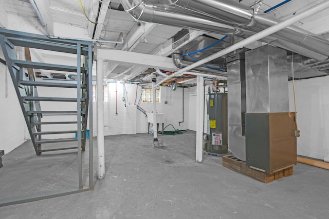 basement featuring stairway, heating unit, and water heater