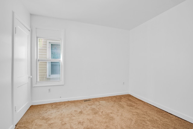 unfurnished room with baseboards, visible vents, and carpet floors