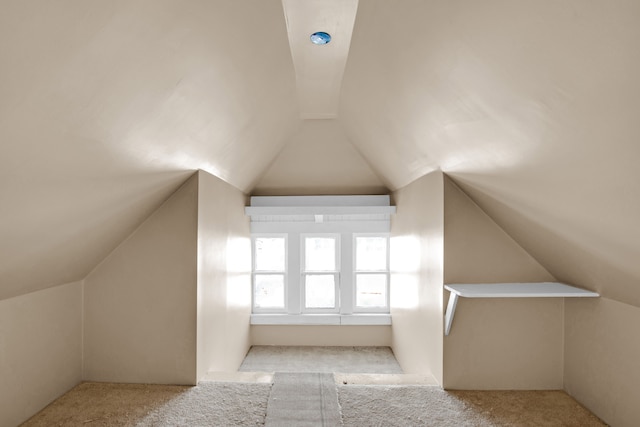 bonus room featuring carpet flooring and vaulted ceiling with beams