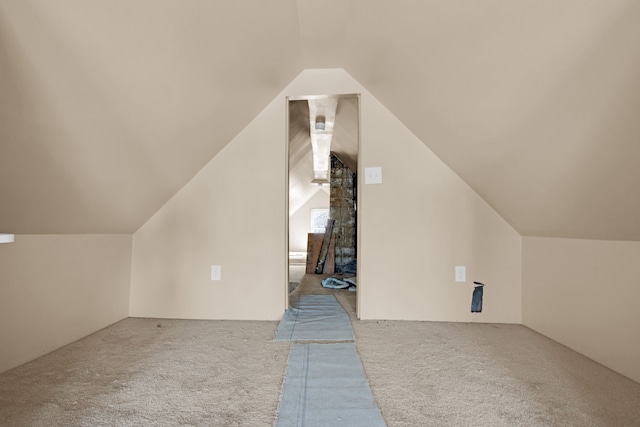 additional living space with carpet flooring and vaulted ceiling