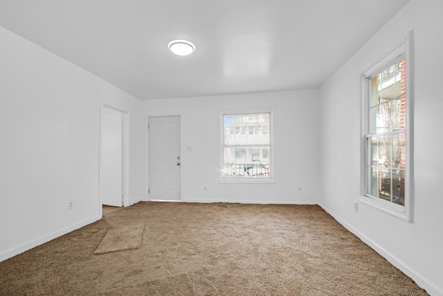 empty room with carpet flooring and baseboards