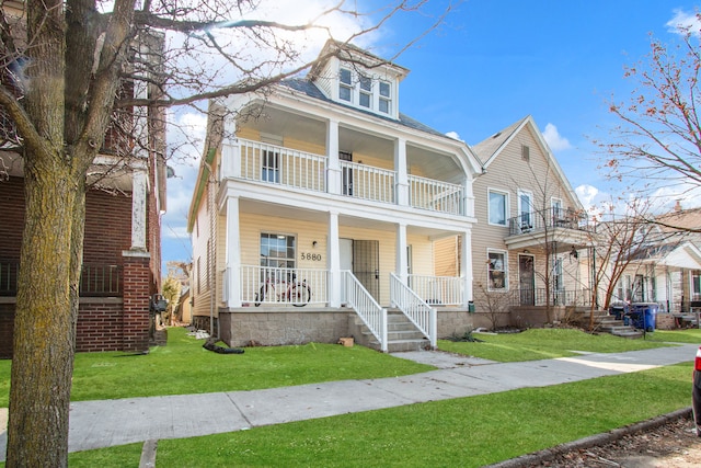 view of front of house with a front lawn, a balcony, and covered porch