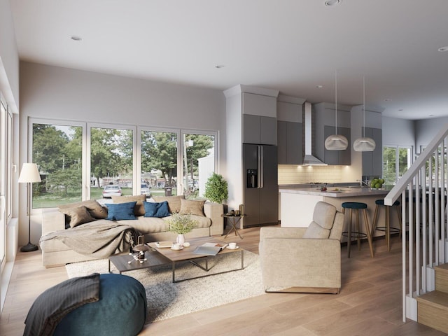 living room featuring recessed lighting, stairway, light wood-style flooring, and plenty of natural light