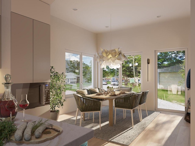 dining space with recessed lighting, light wood-style floors, and an inviting chandelier