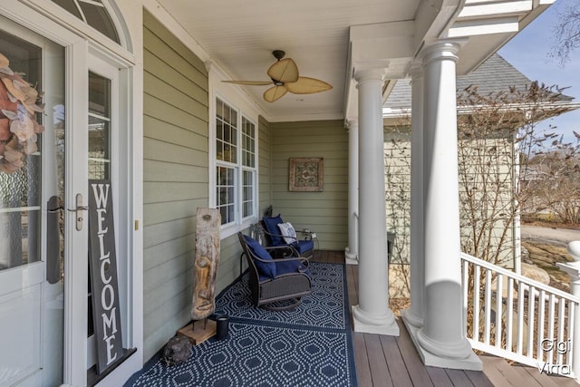 wooden deck with a porch and ceiling fan