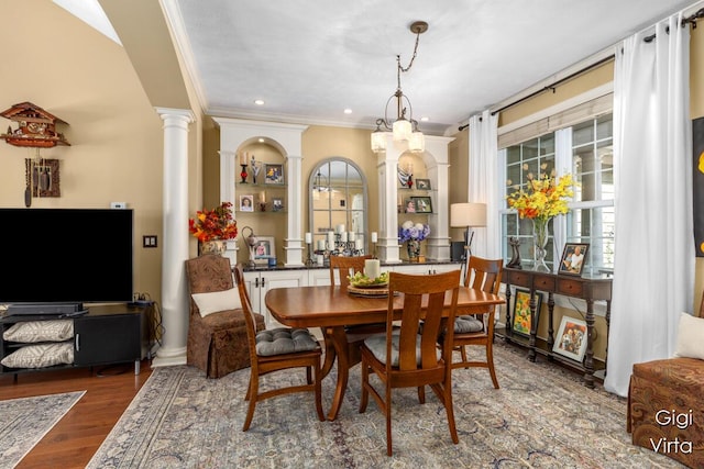 dining space with recessed lighting, crown molding, ornate columns, and wood finished floors