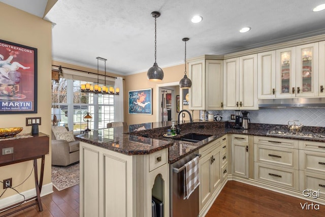 kitchen featuring a sink, cream cabinetry, ornamental molding, and dark wood finished floors