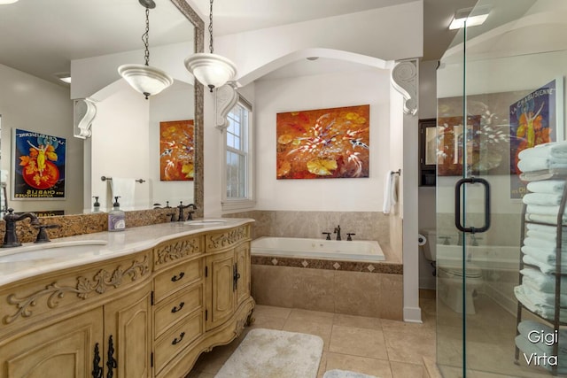 full bath featuring a sink, a garden tub, a shower stall, and tile patterned floors