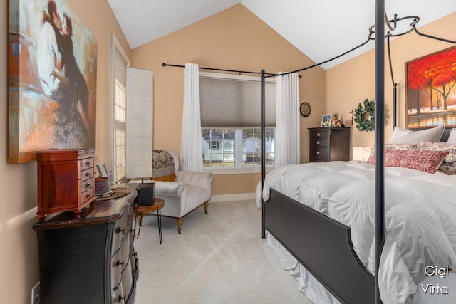 bedroom with lofted ceiling, baseboards, and light carpet