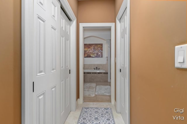 corridor with light tile patterned floors