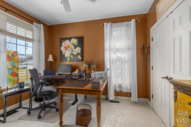 office space featuring carpet flooring, baseboards, and a ceiling fan