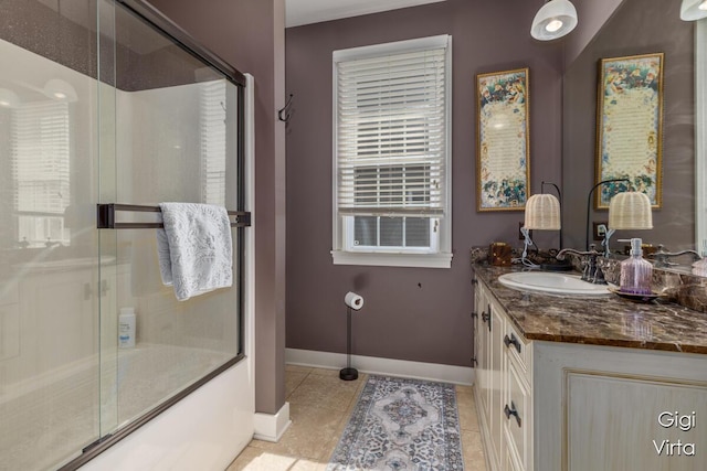 full bath with vanity, tile patterned floors, combined bath / shower with glass door, and baseboards