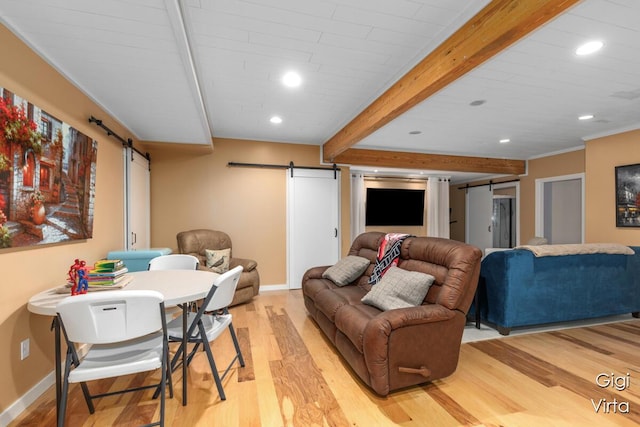 living room with beamed ceiling, light wood-style floors, and a barn door