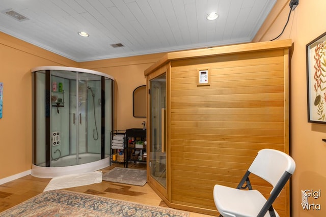 full bath with visible vents, wood finished floors, recessed lighting, a shower stall, and crown molding